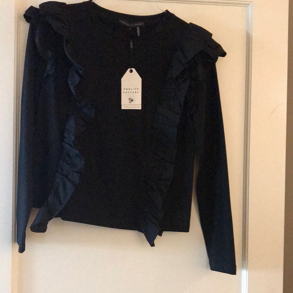 Black top with cute ruffles sleeve.  Never worn.